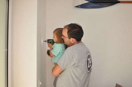 Helping Papa take the screws out of the wall